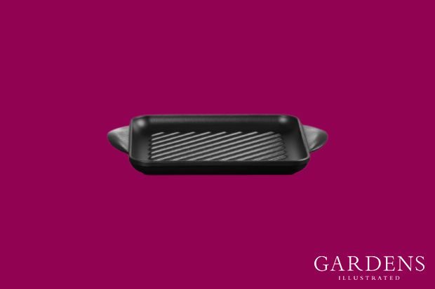 Le Creuset grill pan on a pink background
