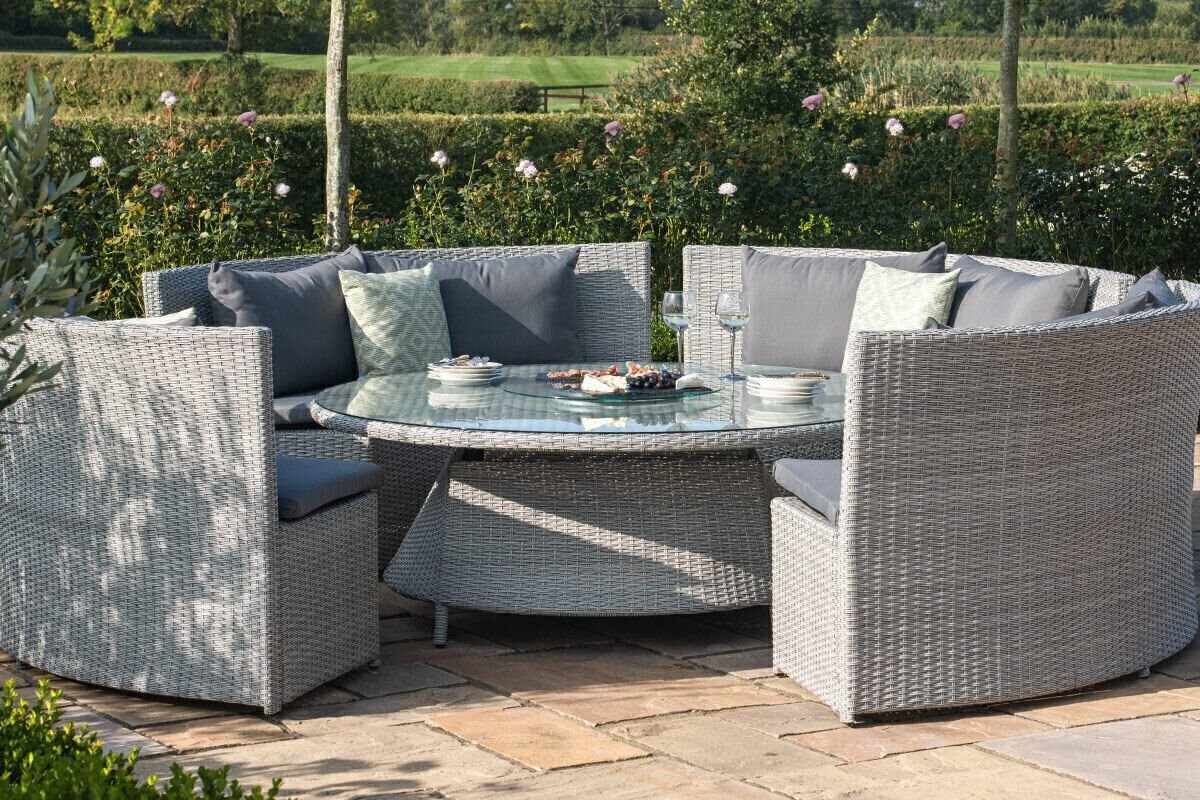 Maze Ascot Round Rattan Sofa Dining Set on a patio