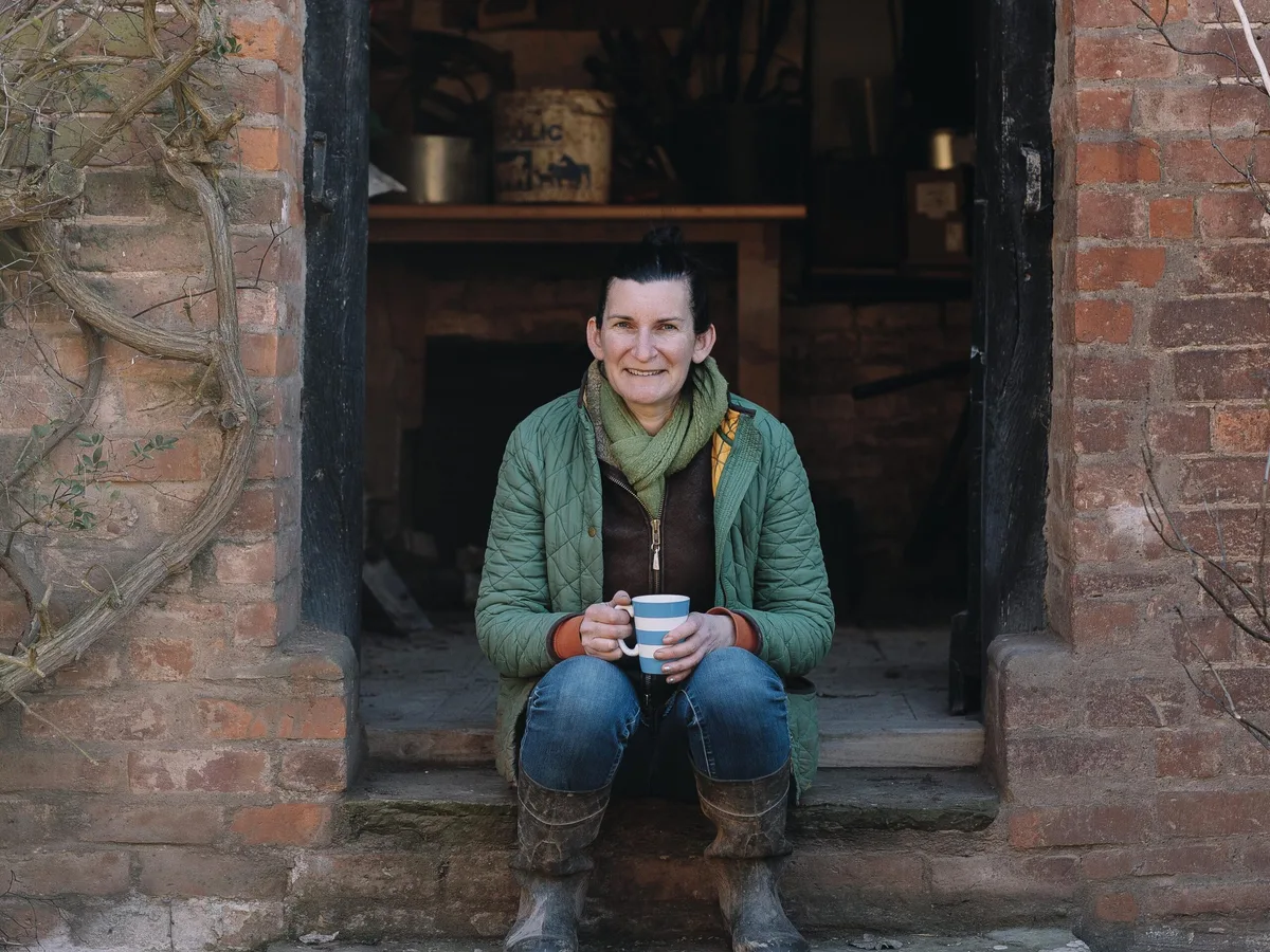 Chelsea Flower Show judge Tamsin Westhorpe Woman sat on steps holding a mug