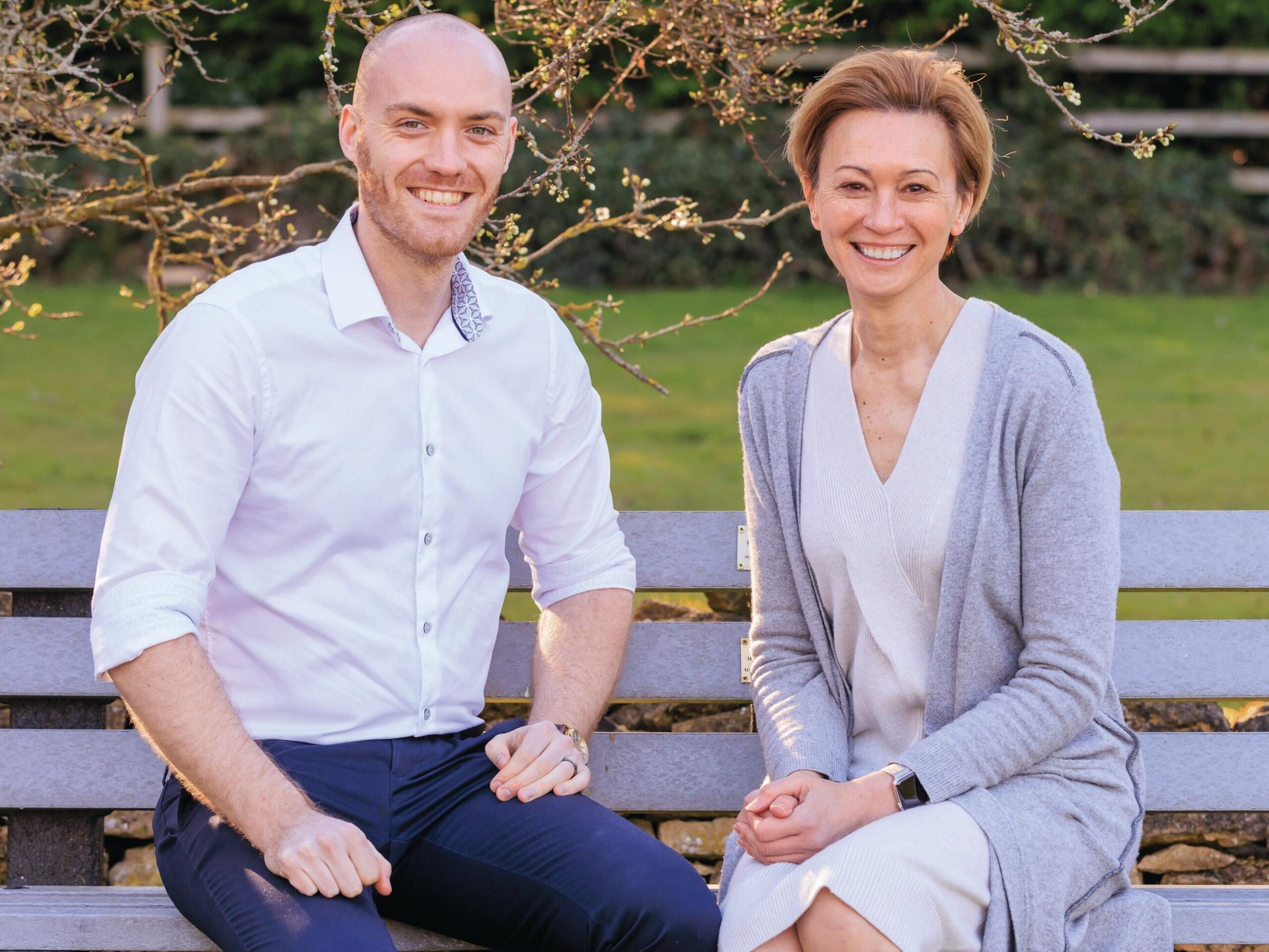 Man and woman sitting on a bench outdoors