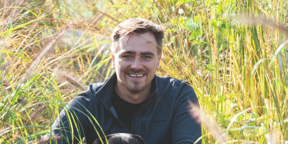 Jamie Butterworth hero Man in grass with dog
