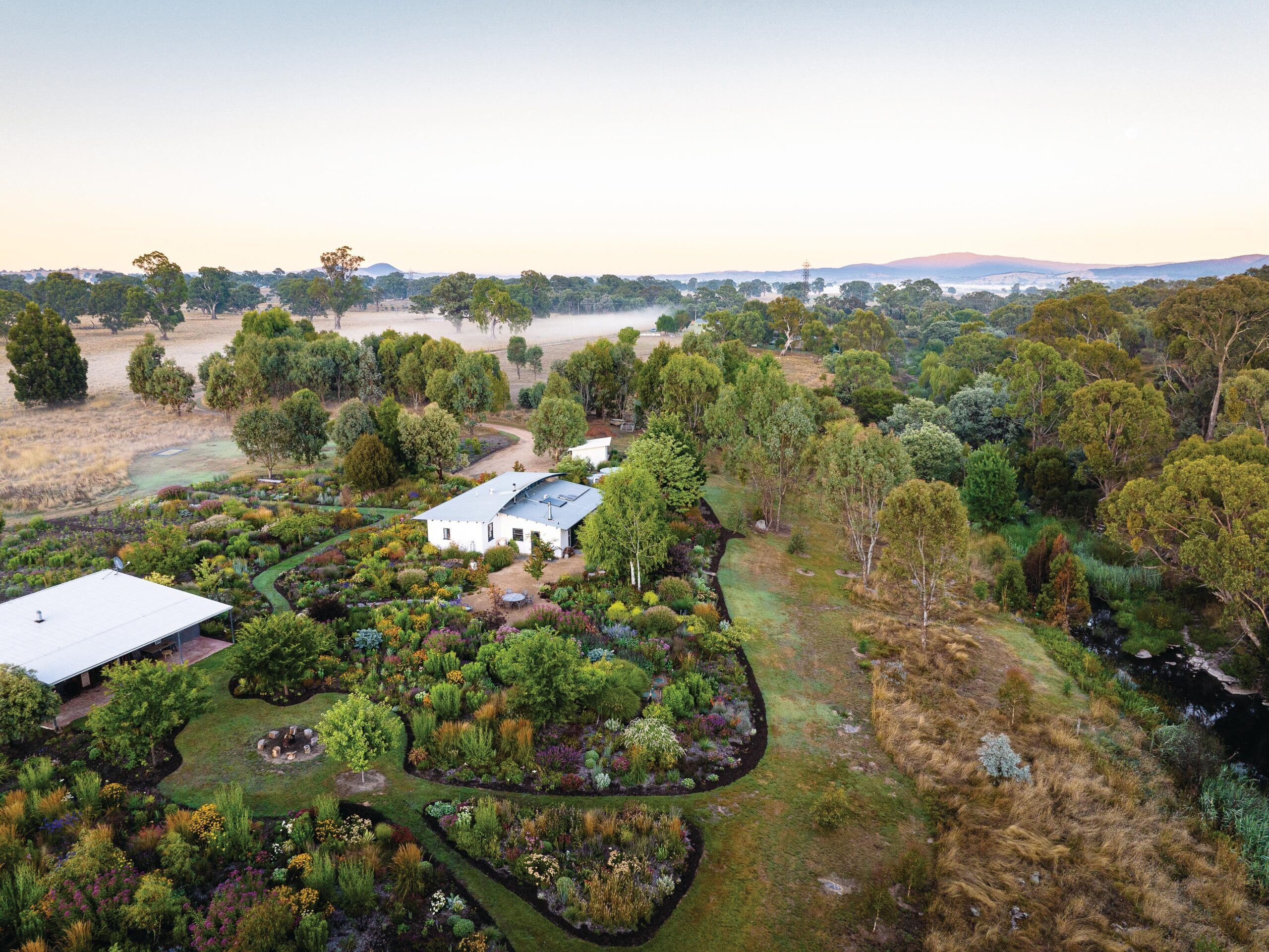 Aerial shot of garden and house with mountains
