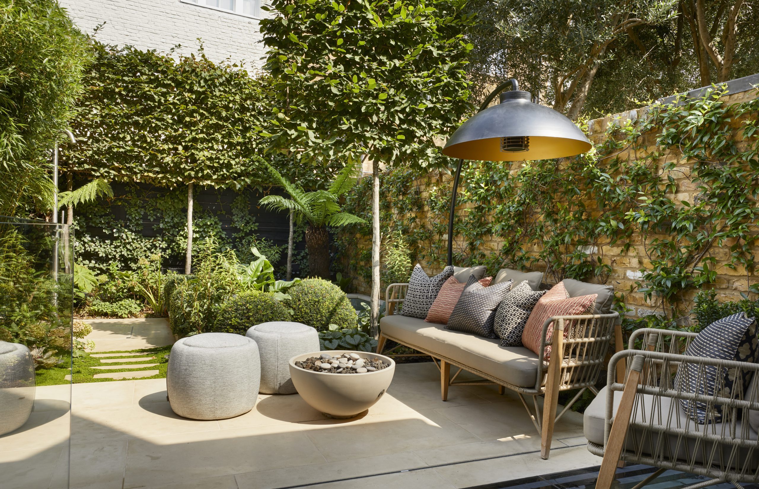 A garden with an outside lamp and seating area