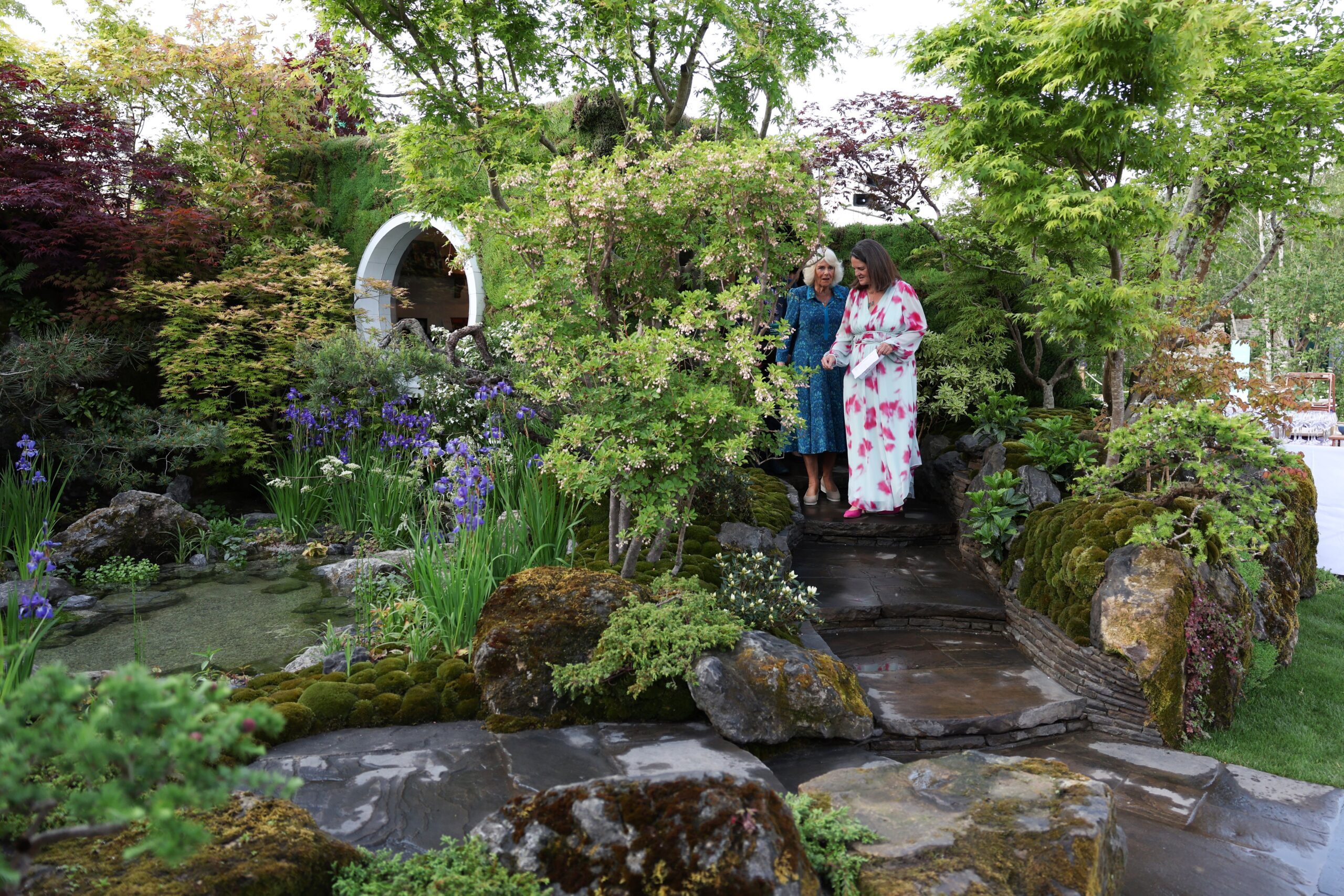 Queen Camilla (L) visits the MOROTO no IE Garden during the 2024 RHS Chelsea Flower Show
