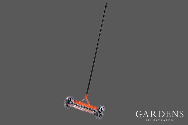Rolling Lawn Scarifier on a grey background