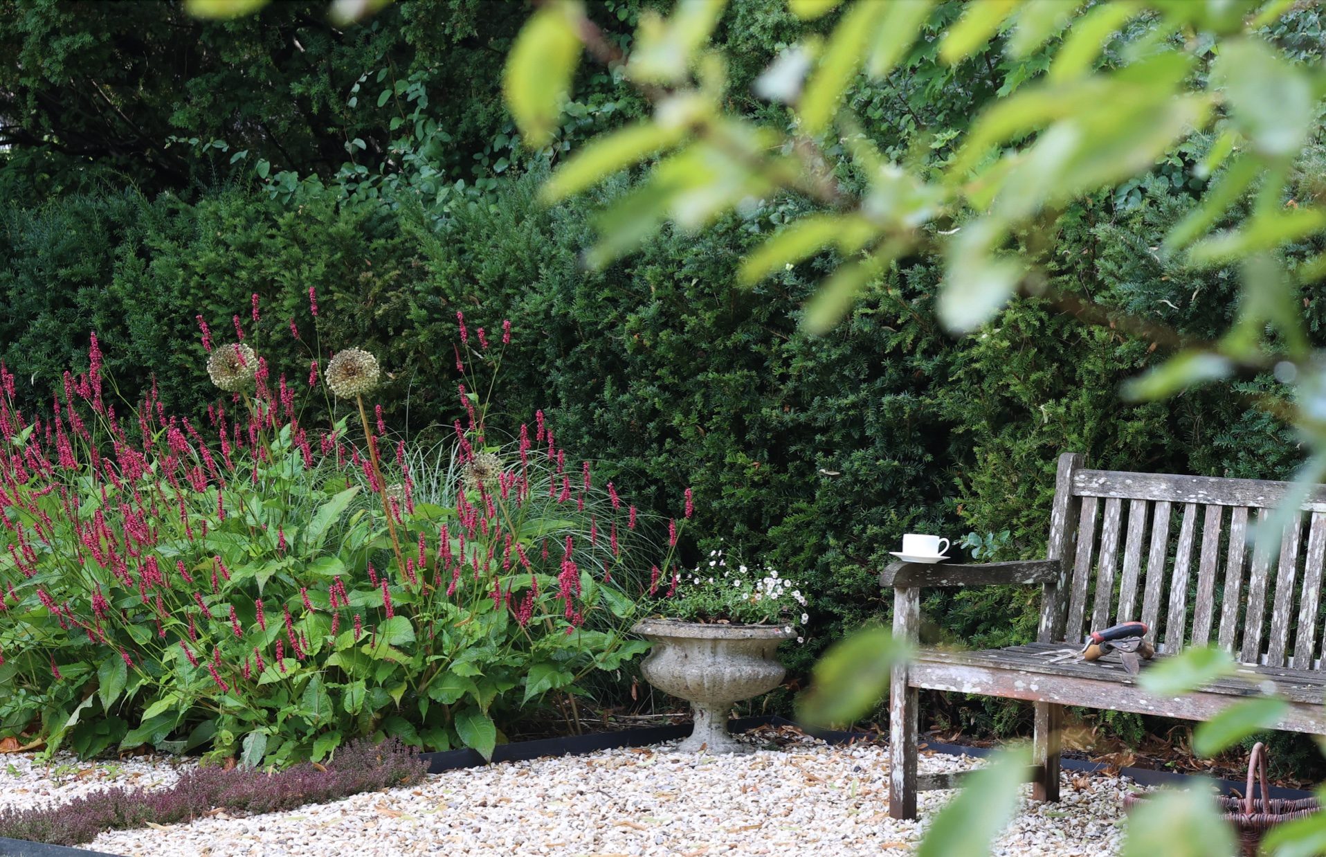 Garden boundaries blur with the foliage beyond in this garden designed by Garden Design Collective