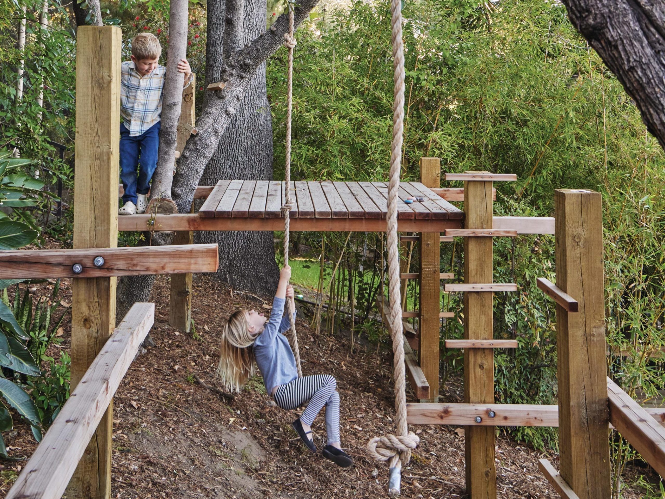 Children playing on climbing frame outdoors
