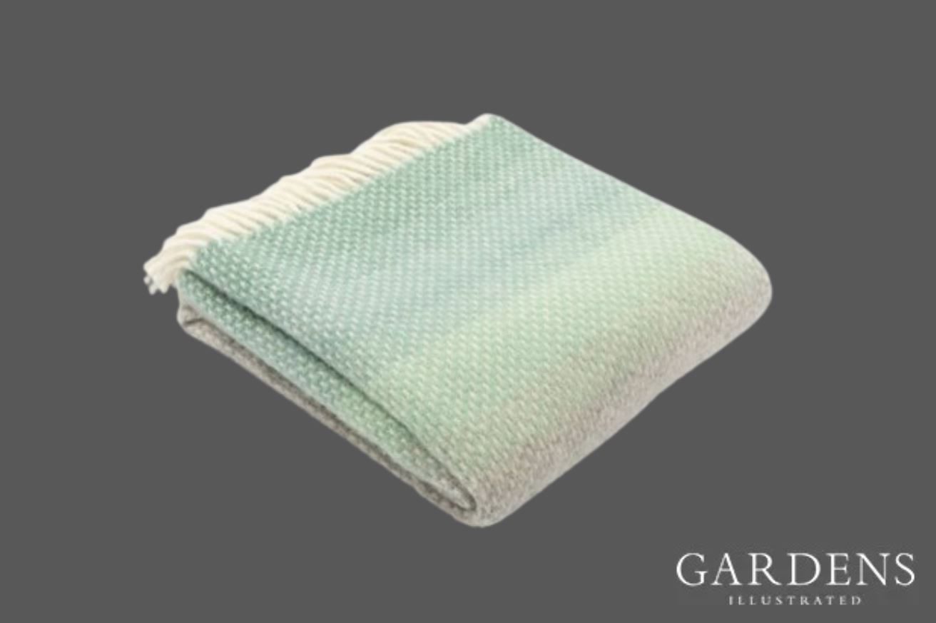 National Trust Ombre Green Throw on a grey background